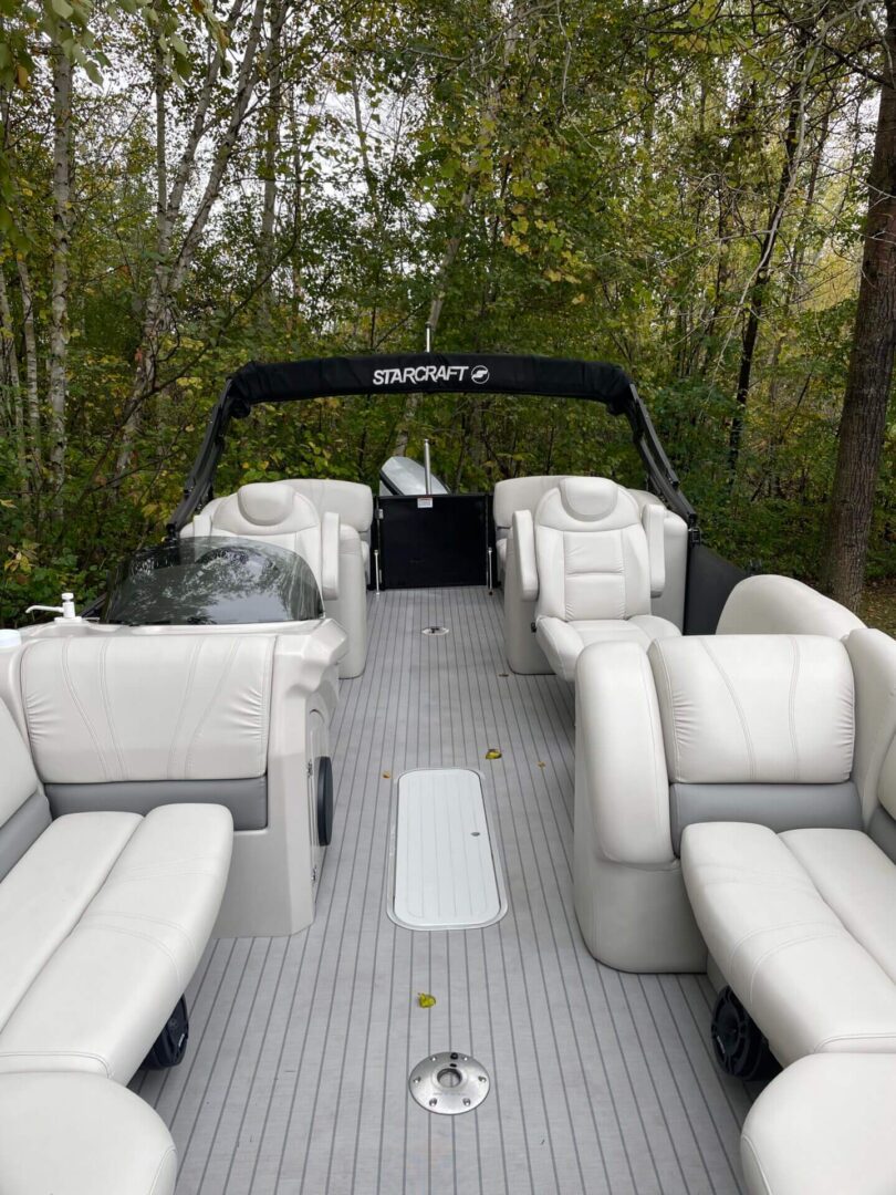 A boat with white seats and black trim.