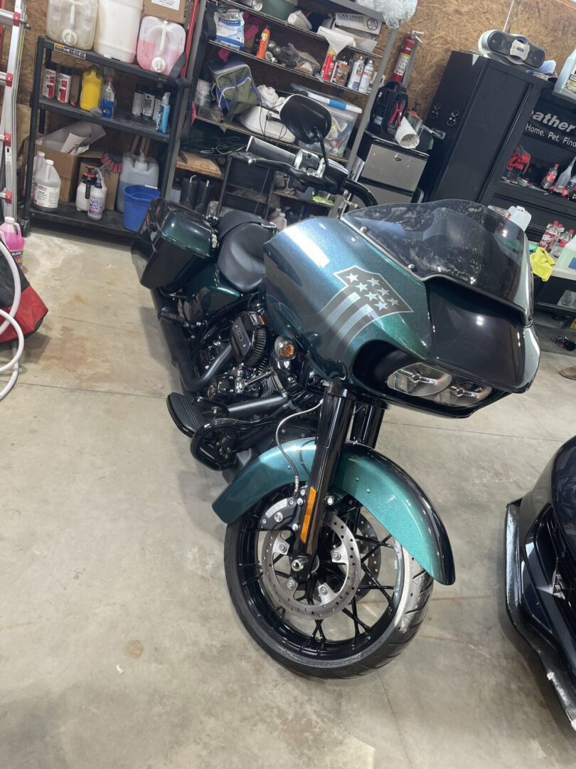 A motorcycle parked in the garage with other motorcycles.