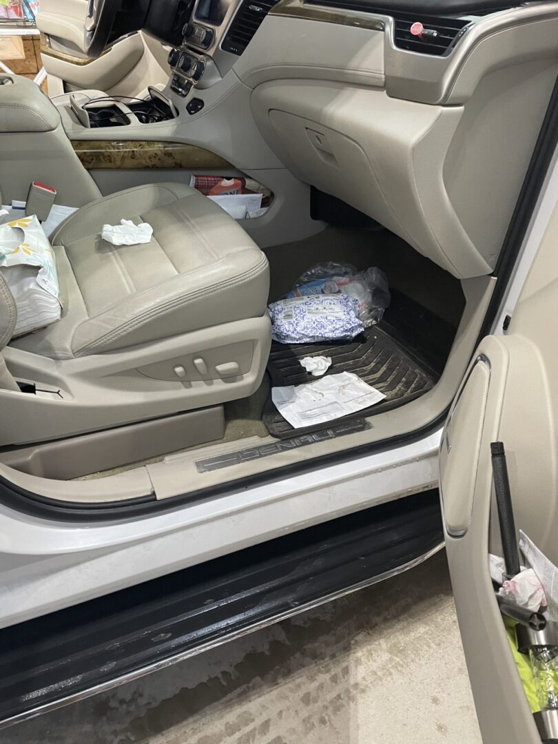 A car with some papers on the floor