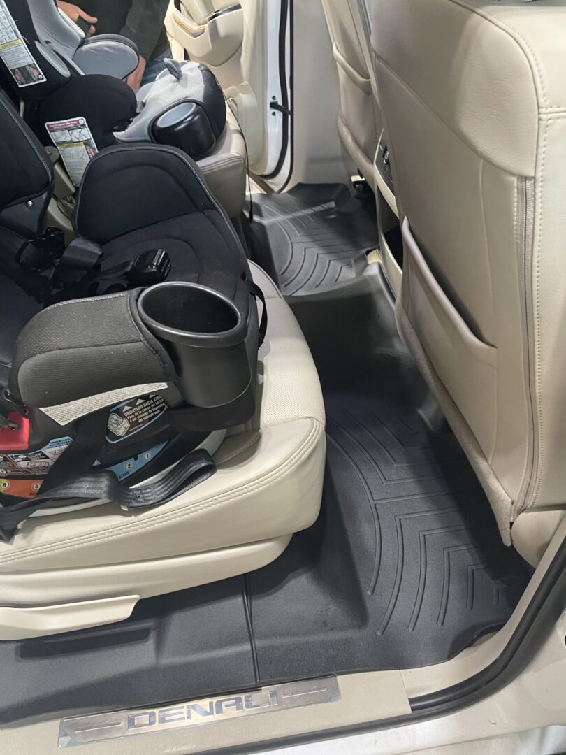 A car seat with the back seats folded down.