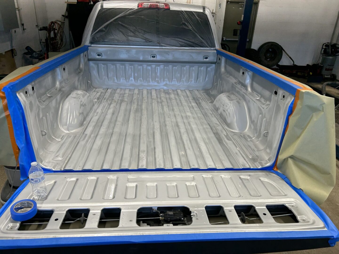 A truck bed with blue paint on it.