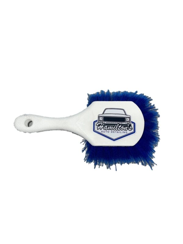 A white and blue brush with a logo on it.